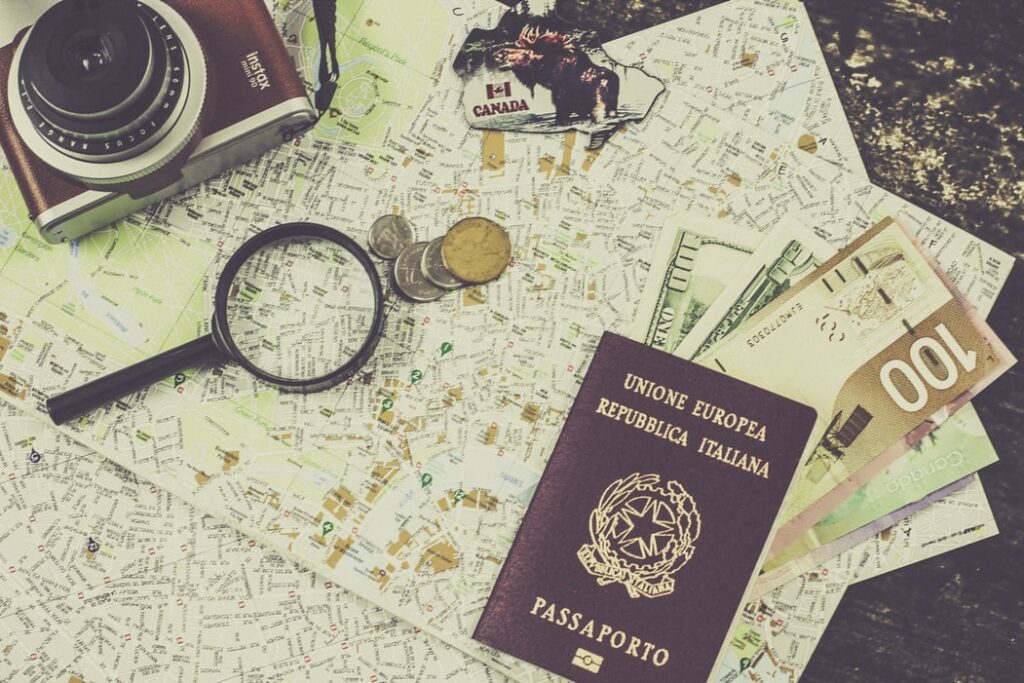 map on table with camera, passport, money and magnifying glass