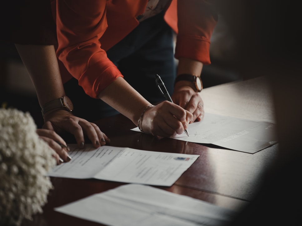 two people filling out documents