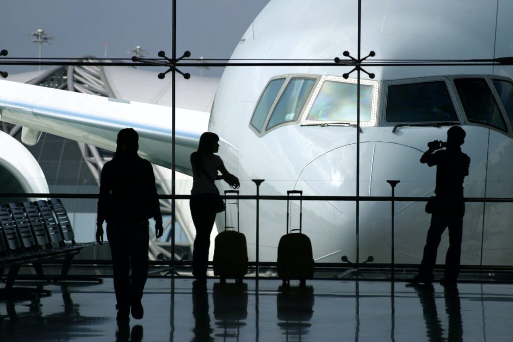 silhouettes of people at airport