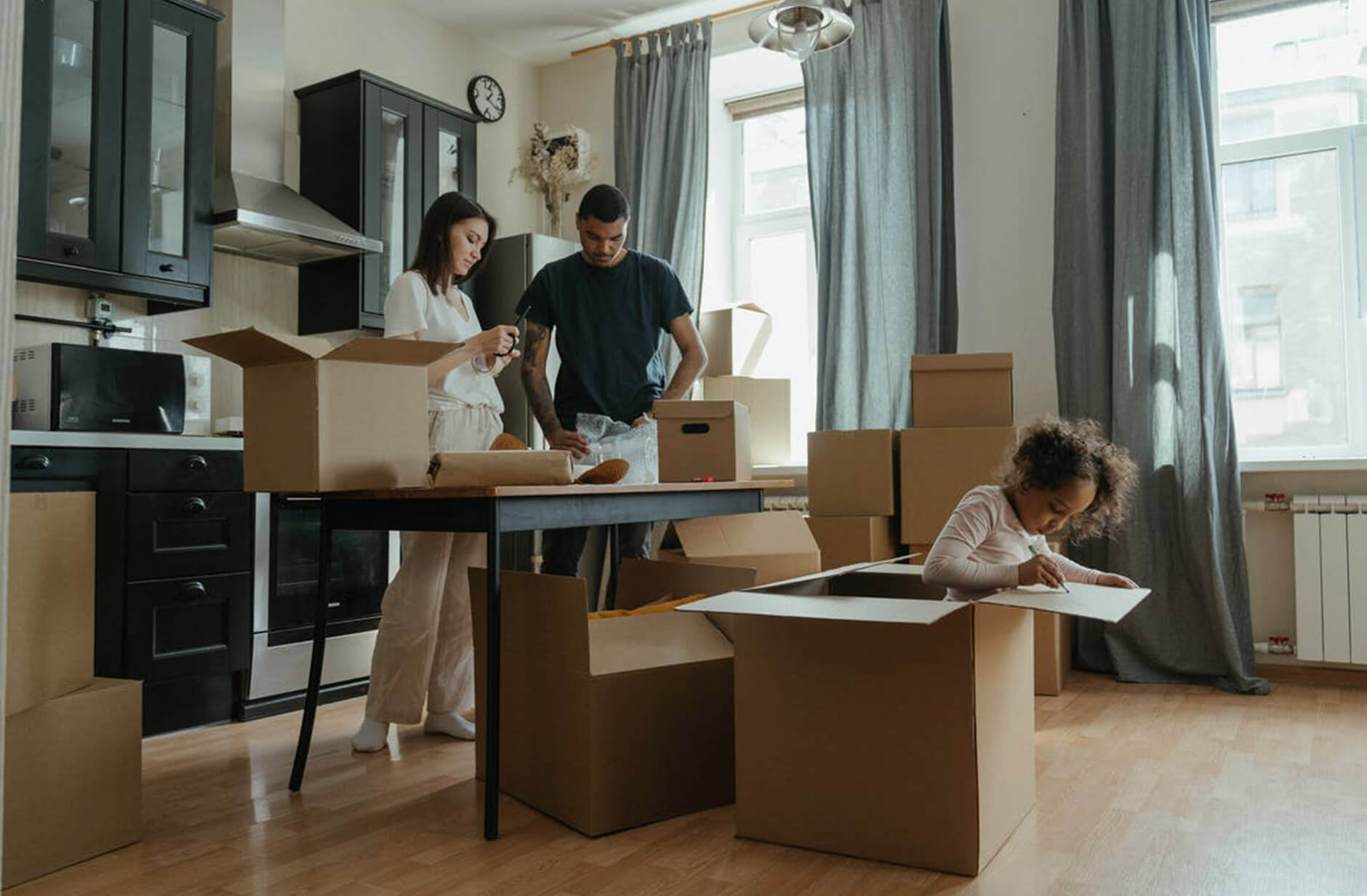 Family unpacking boxes in new home