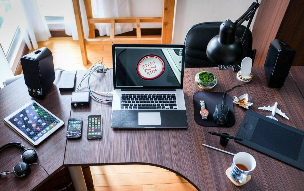 Black and White Laptop Computer on Brown Wooden Desk