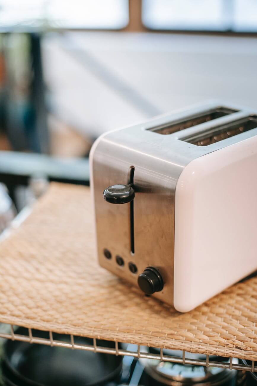 Modern toaster on shelf in kitchen