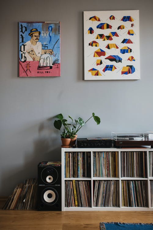 Collection of vinyl records on shelf in apartment