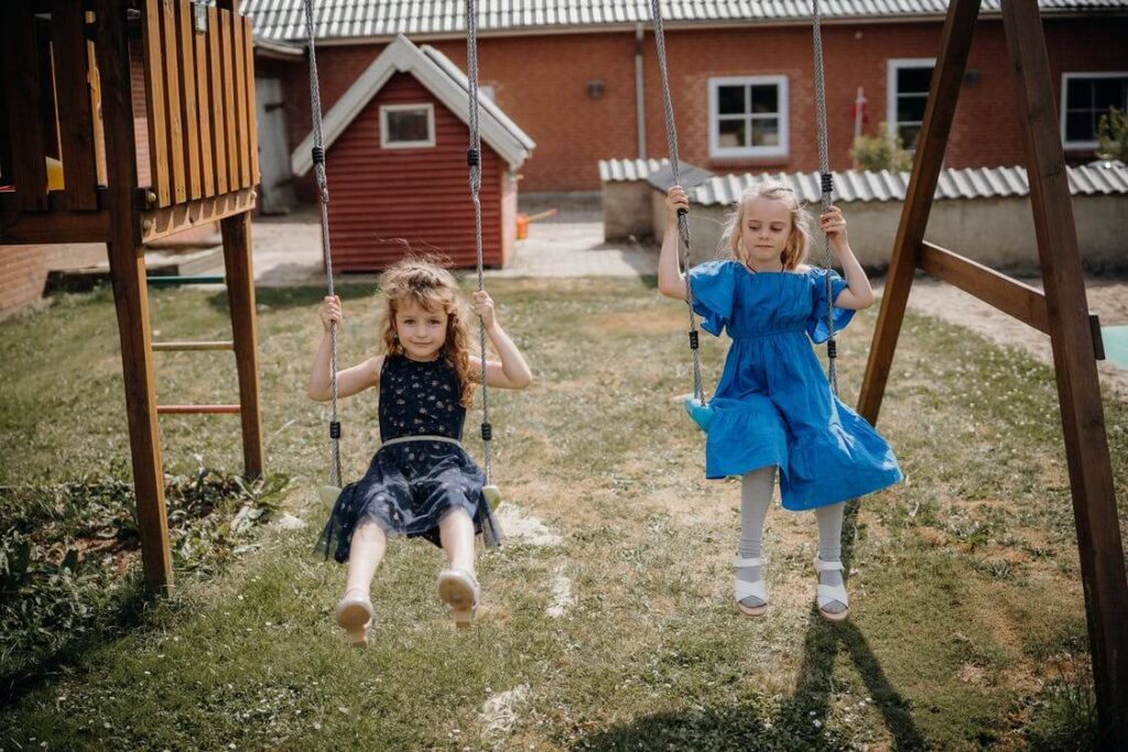 Girls Riding Swings