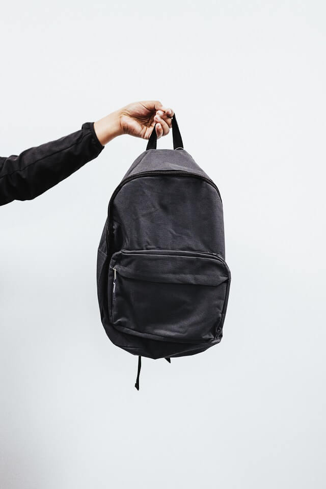 Person Holding Black Backpack