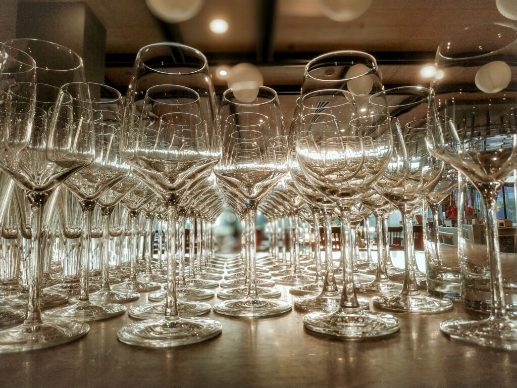 Clear Wine Glasses on Brown Wooden Table