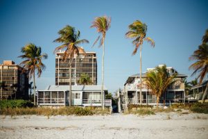 Palm Trees and Beach Houses Under Blue Sky during Daytime