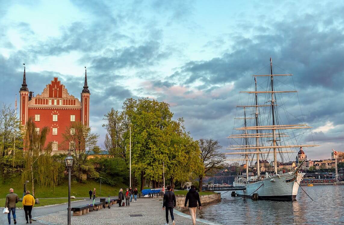 people walking on boardwalk in Stockholm, Sweden